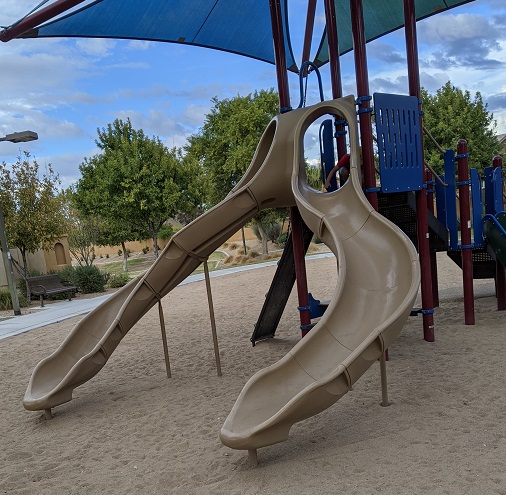 Example of playground in accordance with playground safety recommendations. playground structure showing two sides descending onto sand