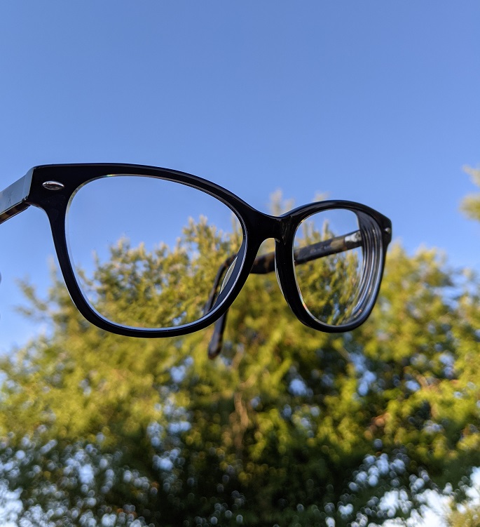 eyeglasses with sky and tree in the background